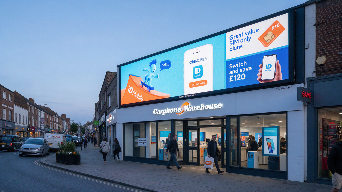 UK high street shop fascia at twilight with a bright outdoor LED display